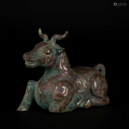 A bronze beast ware with gold and silver