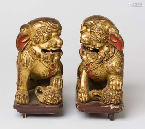 TWO CHINESE GILDED WOODEN GUARDIAN LIONS