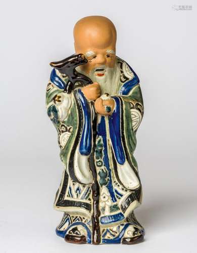 A CERAMIC FIGURE OF A WISE MAN