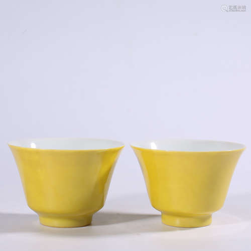 A pair of yellow glazed cups