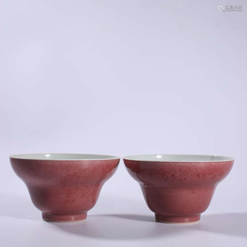 A pair of red glazed folding bowls