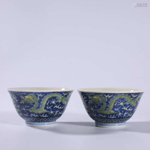 A pair of yellow bowls with blue background