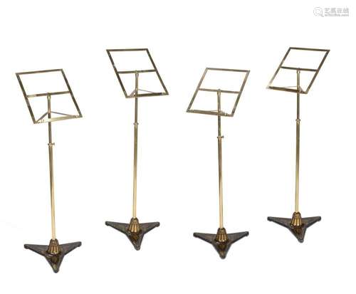 A SET OF FOUR BRASS AND CAST IRON MUSIC STANDS, IN THE STYLE...