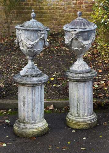 A PAIR OF GEORGE III STYLE LEAD LIDDED URNS, PROBABLY MID/EA...