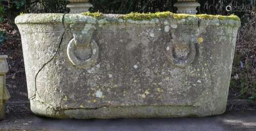 A WEATHERED STONE TROUGH IN THE FORM OF A ROMAN BATH POSSIBL...