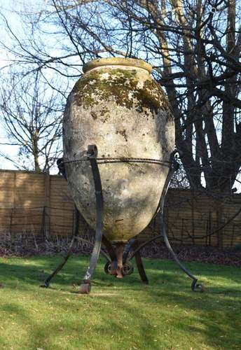 A MONUMENTAL TERRACOTTA VASE OR 'PITHOS' ON IRON STA...