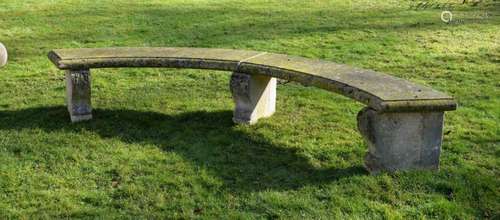 A CARVED PORTLAND STONE CURVED GARDEN SEAT, 19TH CENTURY, of...