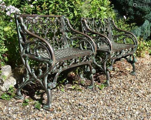 A PAIR OF CAST IRON SINGLE BENCHES, IN THE GOTHIC STYLE, MOD...