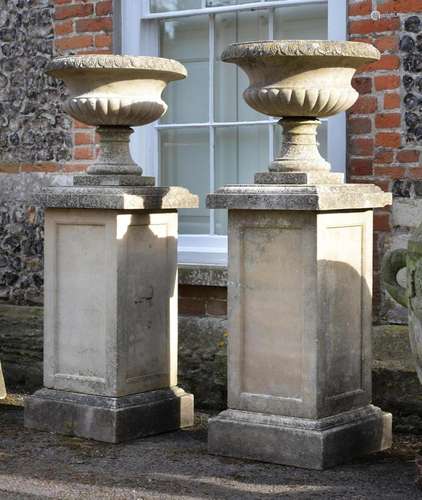 A PAIR OF HADDONSTONE URNS AND PEDESTALS, 20TH CENTURY