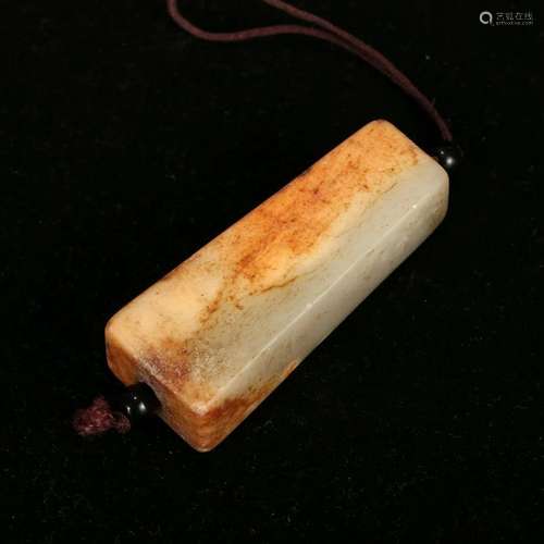 A WHITE AND RUSSET JADE PENDANT