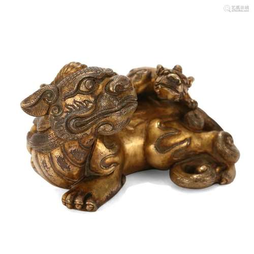 A GILT-BRONZE 'BEAST' CARVING