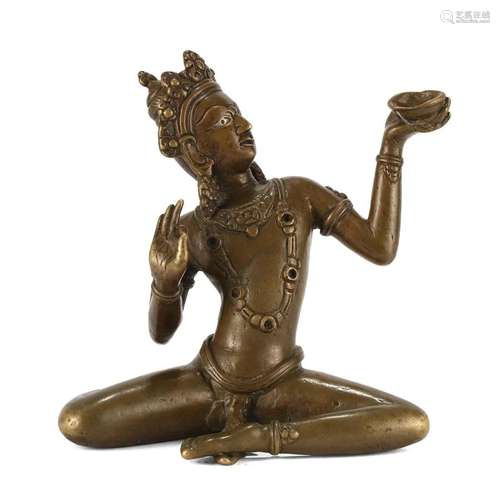 A BRONZE FIGURE OF A SEATED GUARDIAN