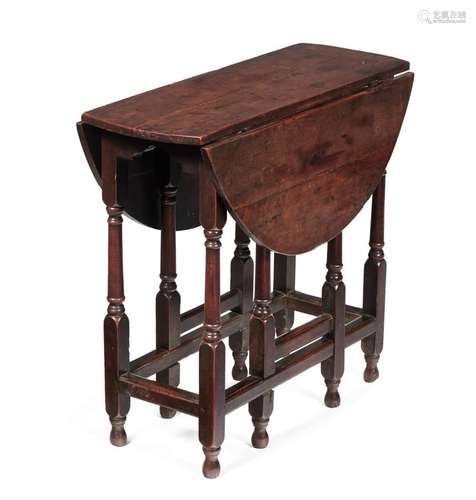 AN UNUSUAL CHARLES II SOLID FRUITWOOD OVAL DROP LEAF TABLE, ...