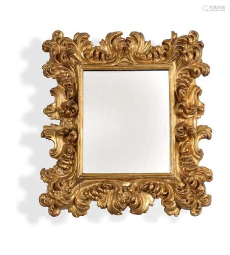 AN ITALIAN CARVED GILTWOOD WALL MIRROR, POSSIBLY FLORENTINE,...