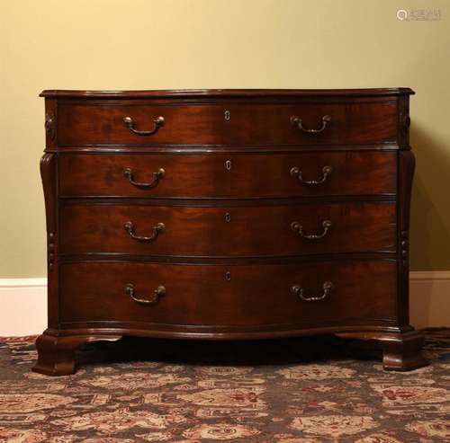 A GEORGE III MAHOGANY SERPENTINE COMMODE, IN THE MANNER OF T...