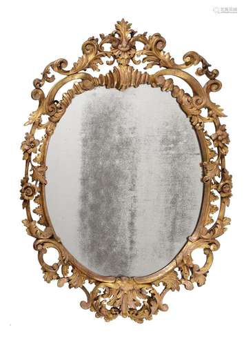 A CARVED GILTWOOD OVAL WALL MIRROR IN GEORGE III STYLE, SECO...