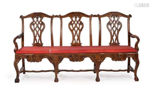 A CARVED WALNUT CHAIR-BACK SETTEE, PROBABLY PORTUGUESE, LATE...