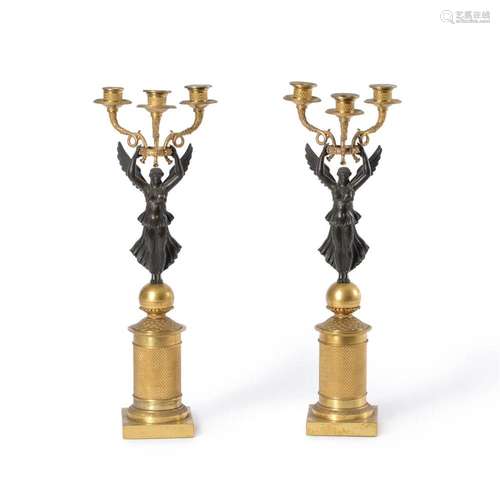 A PAIR OF FRENCH BRONZE AND GILT METAL THREE-LIGHT FIGURAL C...