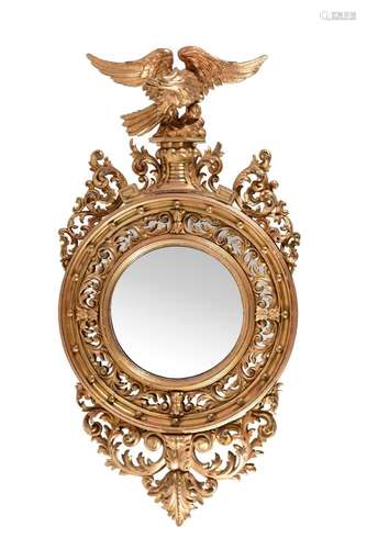 A REGENCY CARVED GILTWOOD CONVEX WALL MIRROR, CIRCA 1820