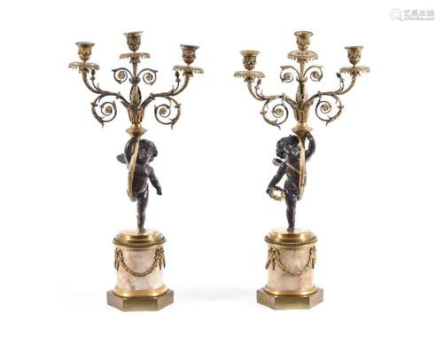 A PAIR OF FRENCH BRONZE AND GILT METAL THREE-LIGHT CANDELABR...