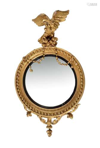 A REGENCY GILTWOOD CONVEX WALL MIRROR, CIRCA 1820