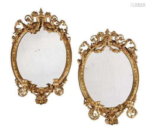 A PAIR OF VICTORIAN GILTWOOD AND COMPOSITION OVAL WALL MIRRO...