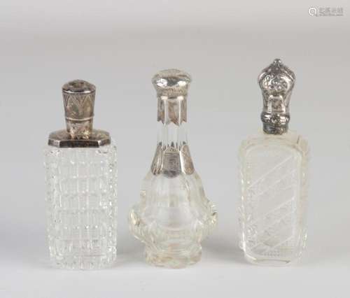 Three perfume bottles with silver