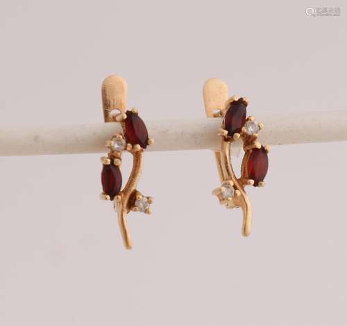 Gold ear studs with garnet