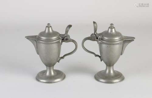 Two tin valve jugs