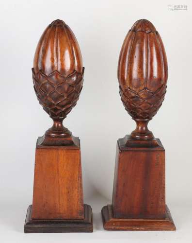 Two mahogany pine cones, H 38 cm.