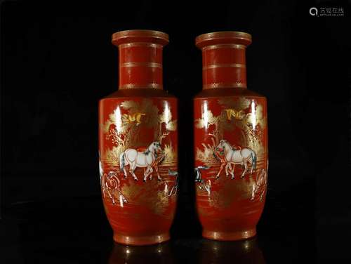 A pair of carmine-ground painted gold vases