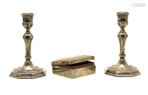 A pair of Queen Anne style silver candlesticks,