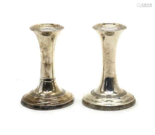 A pair of Edwardian silver dwarf candlesticks