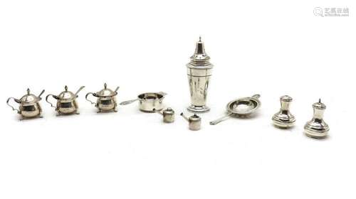 A collection of silver condiment items,