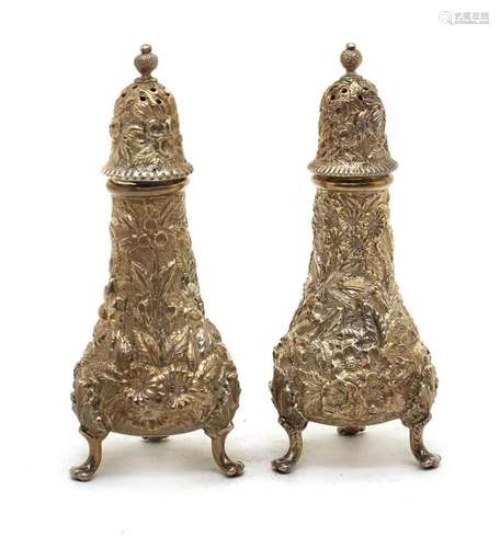 A pair of American silver cast pepperettes,