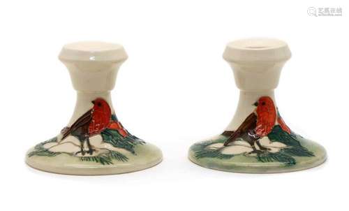 A pair of Moorcroft pottery Christmas Robin dwarf candlest...