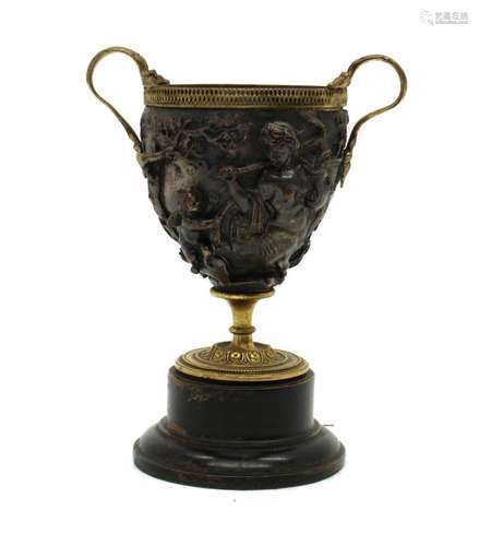 A cast and gilt metal two handled goblet,