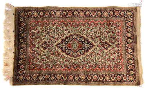 A silk Kashan rug,