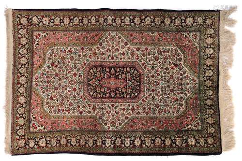 A silk Kashan rug,