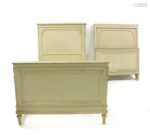 A pair of Louis XVI style painted single bedsteads,