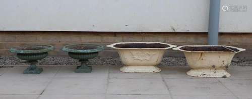 Two pairs of cast iron garden urns,