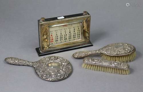 A hand mirror, clothes brush, & hair brush with embossed...