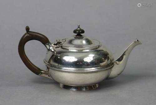 A George V silver teapot of squat round form with central mo...