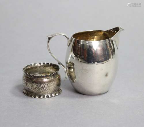 A plain silver barrel-shaped cream jug with scroll handle, 3...