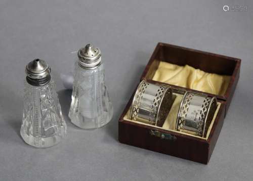 A pair of silver napkin rings; & a pair of silver-topped...