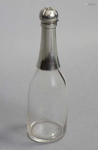 A LATE VICTORIAN SILVER-MOUNTED GLASS NOVELTY DECANTER, in t...