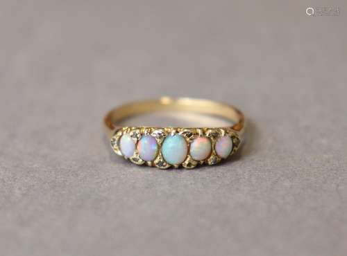 An opal ring, the five graduated oval stones set within a bo...