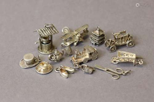 Thirteen various white metal pendant charms (loose), three o...