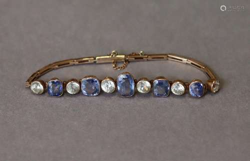 A 9K flexible bracelet set five graduated pale sapphires wit...