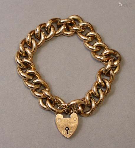 A 9ct. gold curb-link bracelet with padlock clasp & safe...